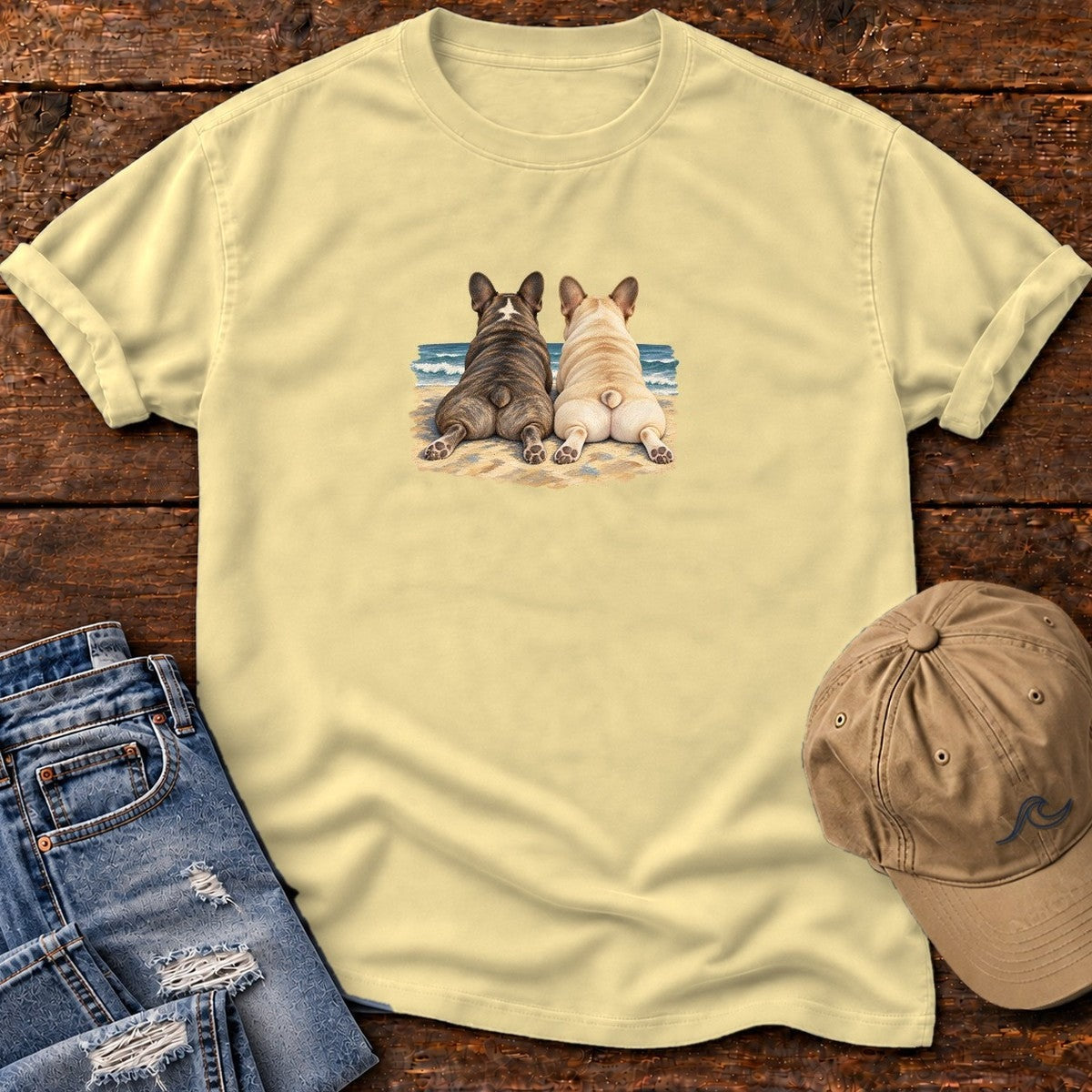 Two French Bulldogs at the Ocean T-Shirt in Butter, Salty Paws Comfort Colors T-Shirt, front design flat lay