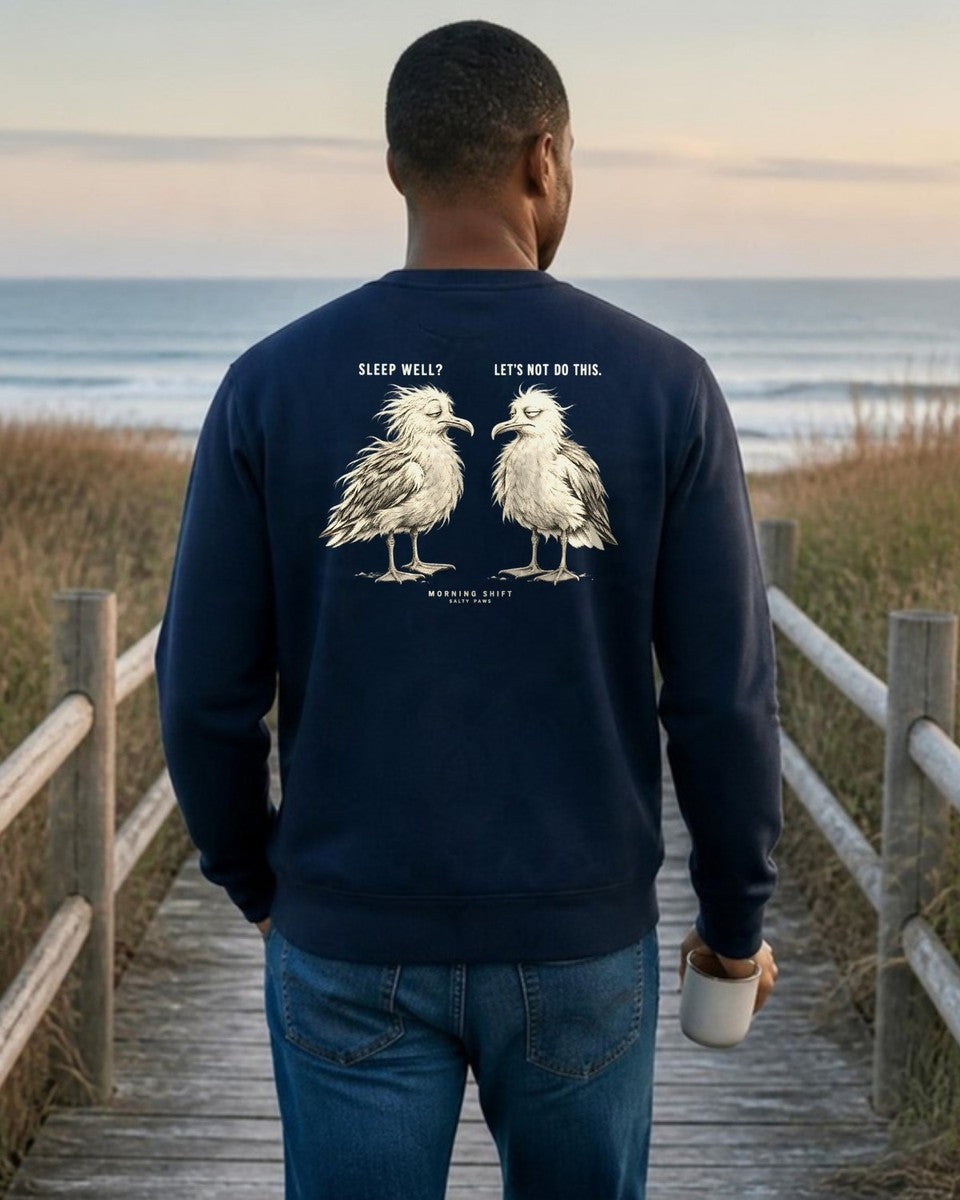 Morning Shift Gulls Back Design Midweight Sweatshirt in Navy, worn by a model on a beach boardwalk, back design