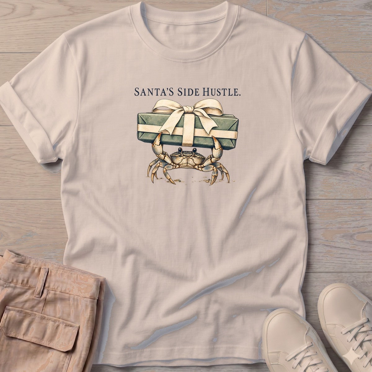 Santa's Side Hustle Crab T-Shirt in Sand, Salty Paws T-Shirt, front design flat lay