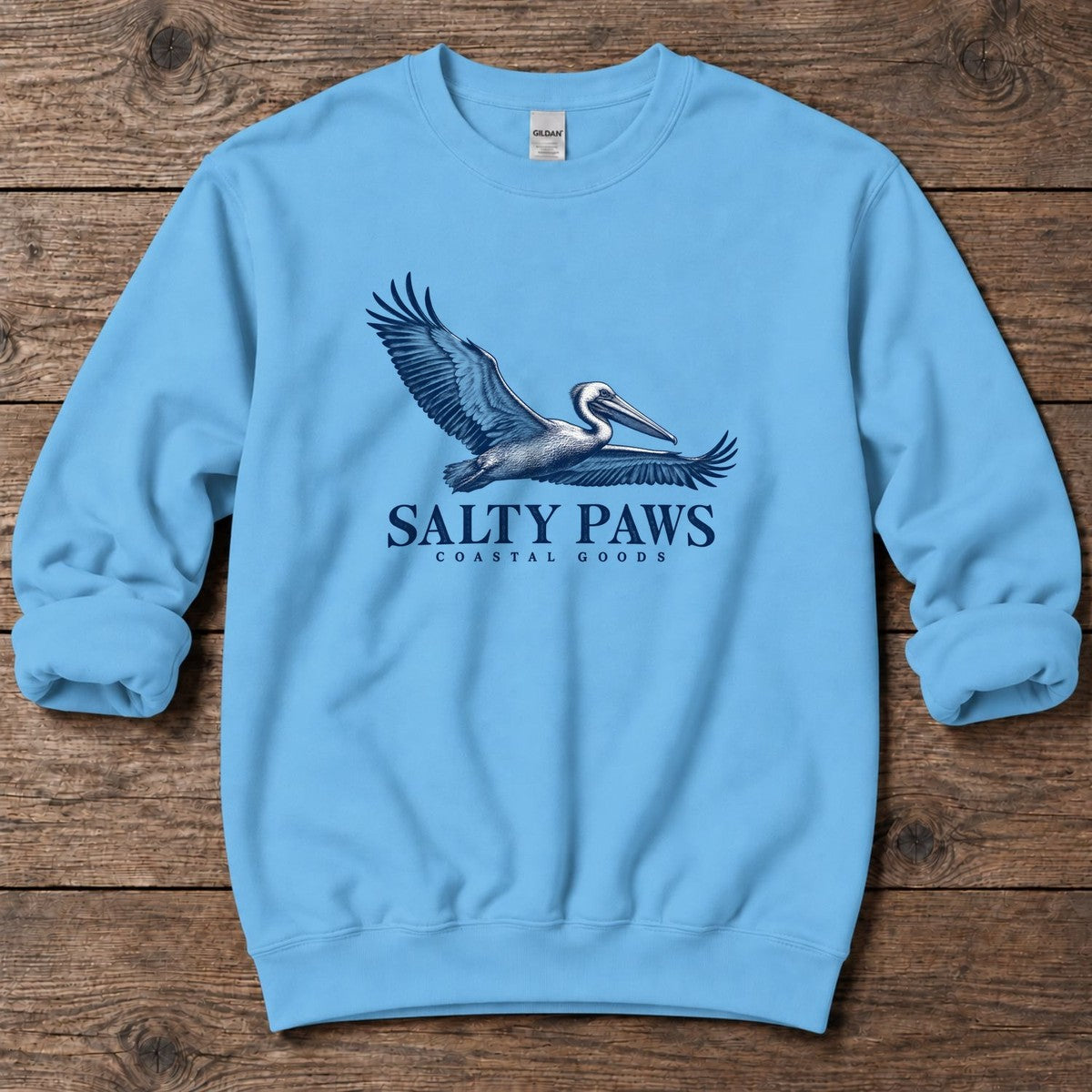 Gliding Pelican Coastal Goods Midweight Sweatshirt in Sky, Salty Paws Midweight Sweatshirt, front design flat lay