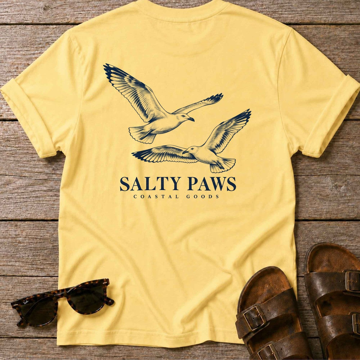 Gull Flight Coastal Goods Back Design T-Shirt in Daisy, Salty Paws T-Shirt, back design flat lay