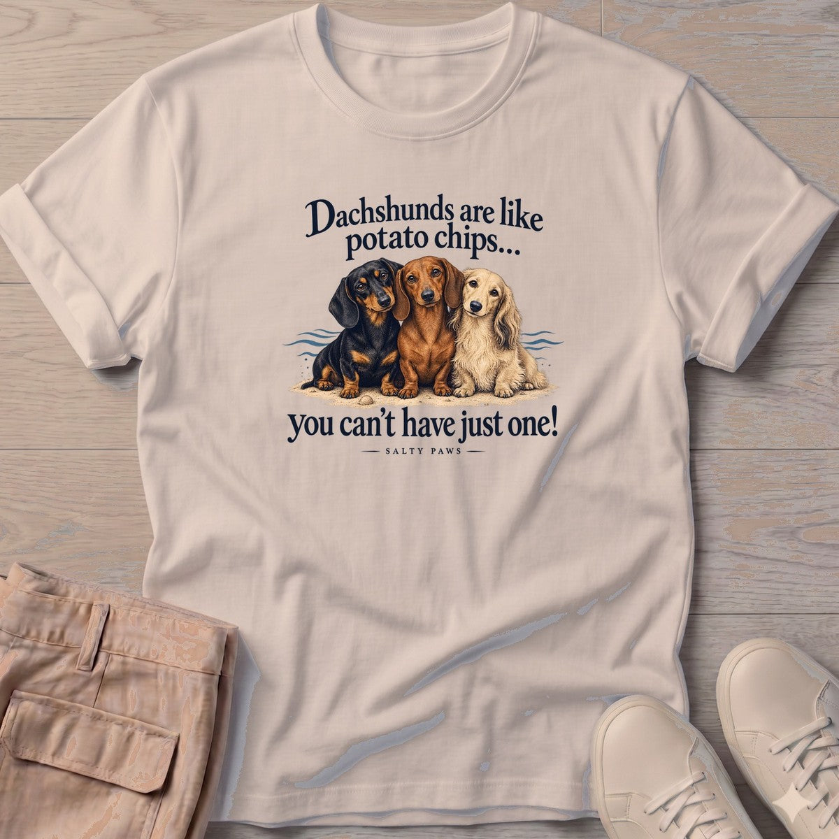 Three Dachshunds Potato Chips T-Shirt in Sand, Salty Paws T-Shirt, front design flat lay