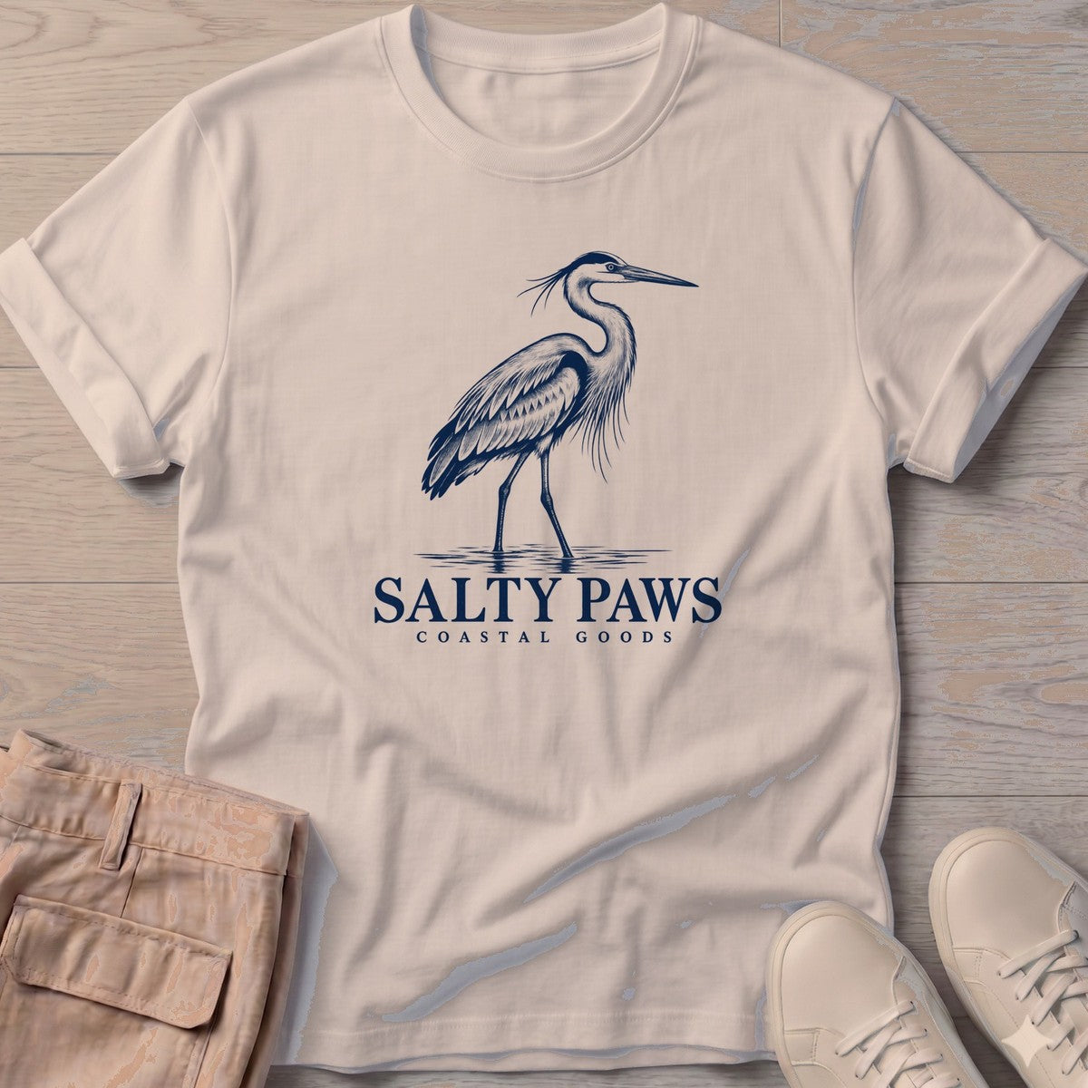 Great Blue Heron Coastal Goods T-Shirt in Sand, Salty Paws T-Shirt, front design flat lay