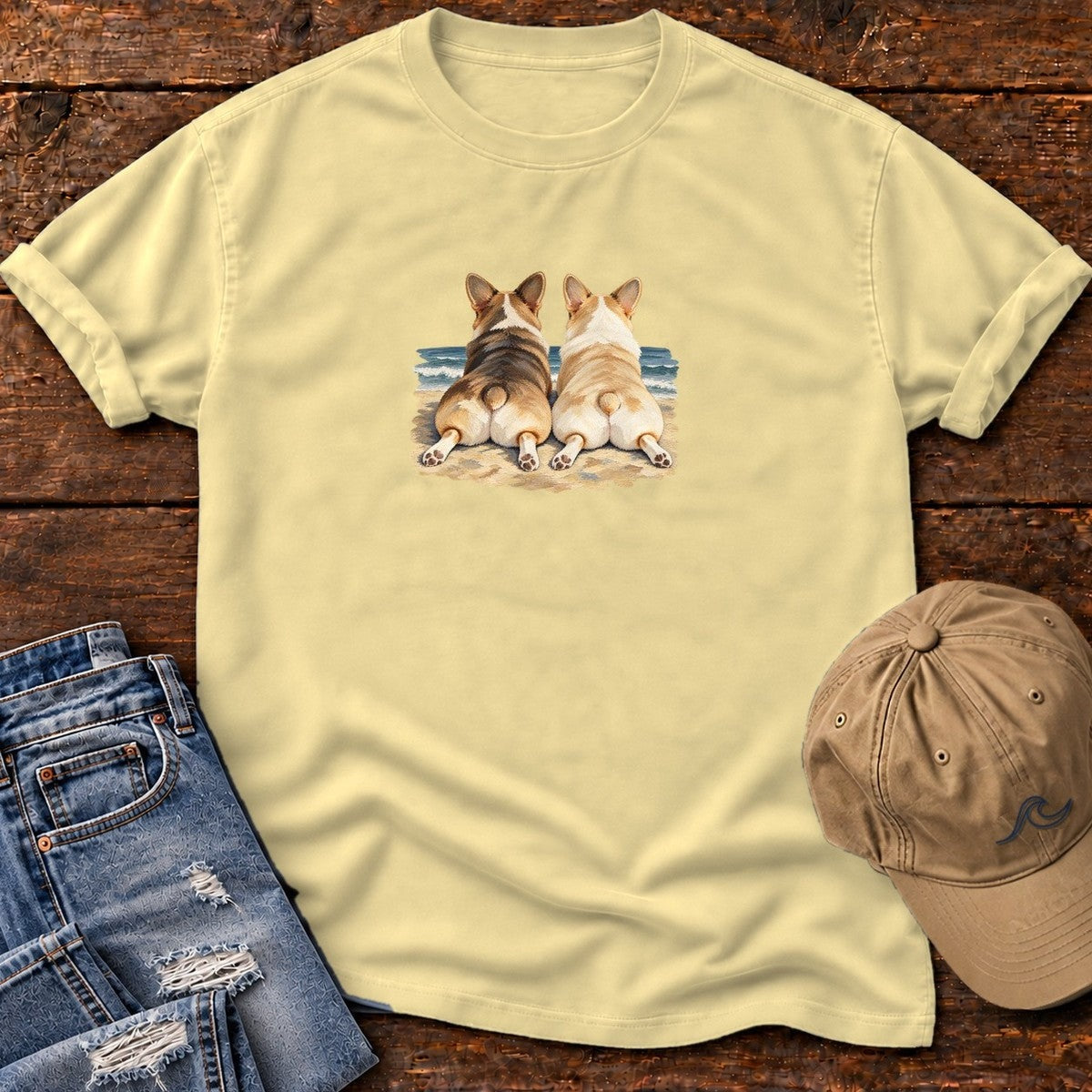 Two Corgis at the Ocean T-Shirt in Butter, Salty Paws Comfort Colors T-Shirt, front design flat lay