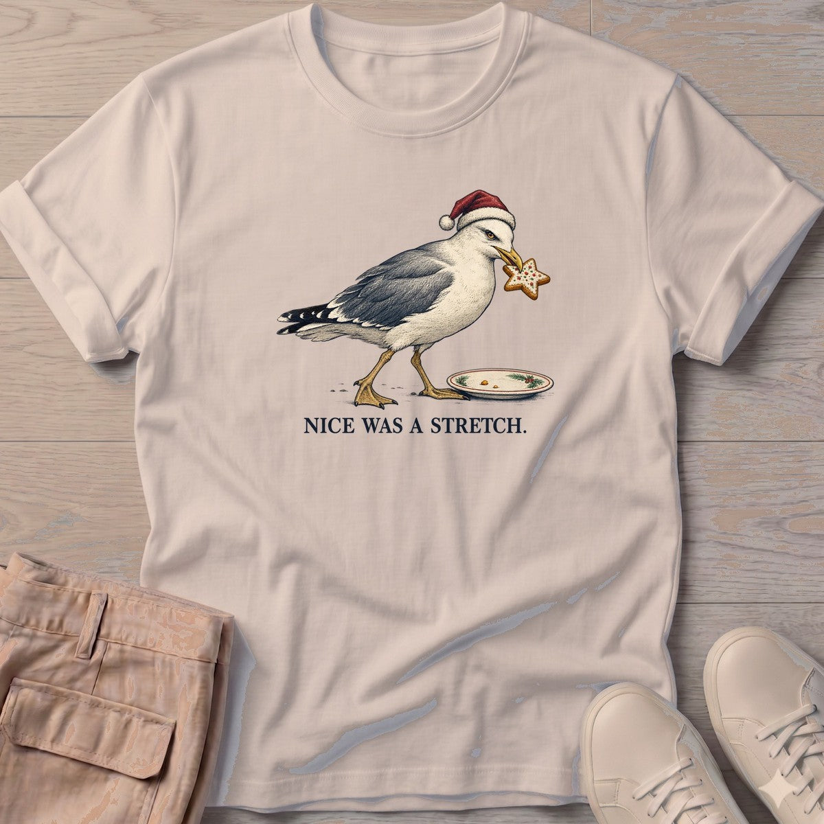 Nice Was a Stretch Seagull T-Shirt in Sand, Salty Paws T-Shirt, front design flat lay
