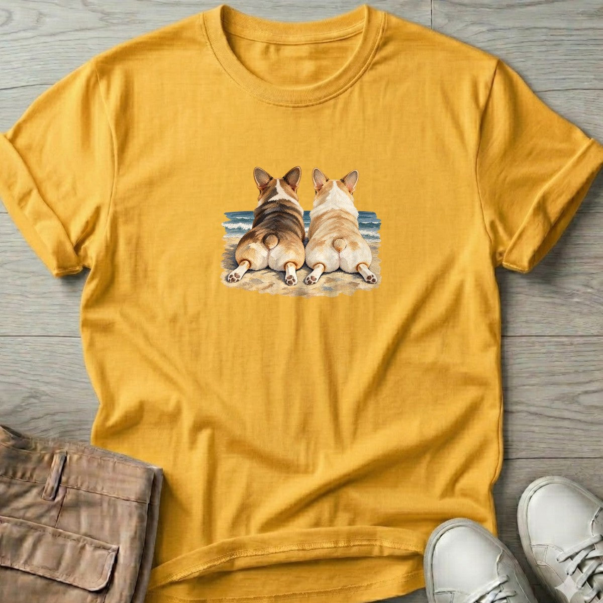 Two Corgis at the Ocean T-Shirt in Daisy, Salty Paws T-Shirt, front design flat lay