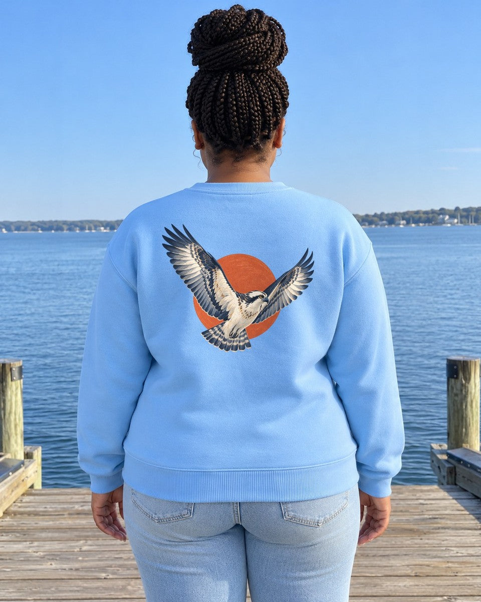 Osprey Red Sun Back Design Midweight Sweatshirt in Sky, worn by a model on a bay dock, back design