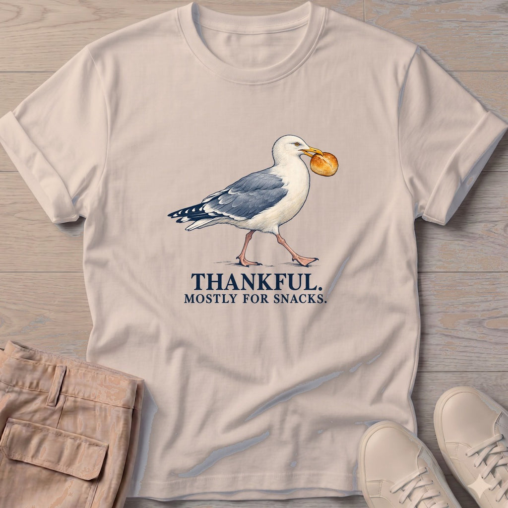 Thankful Mostly for Snacks Seagull T-Shirt in Sand, Salty Paws T-Shirt, front design flat lay