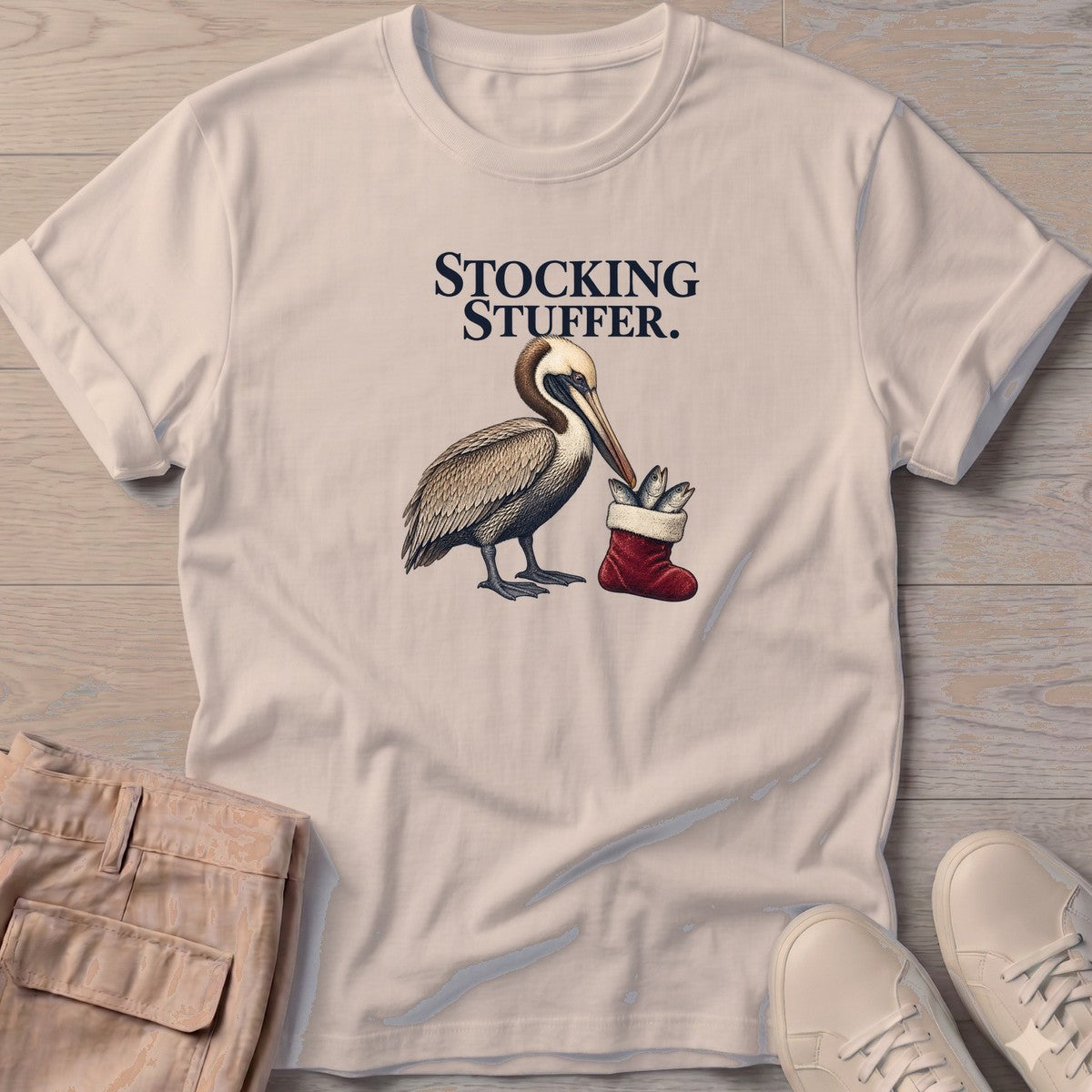Stocking Stuffer Pelican T-Shirt in Sand, Salty Paws T-Shirt, front design flat lay