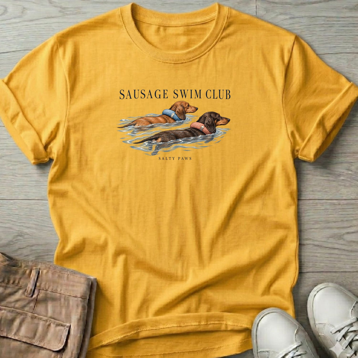 Sausage Swim Club Dachshunds T-Shirt in Daisy, Salty Paws T-Shirt, front design flat lay