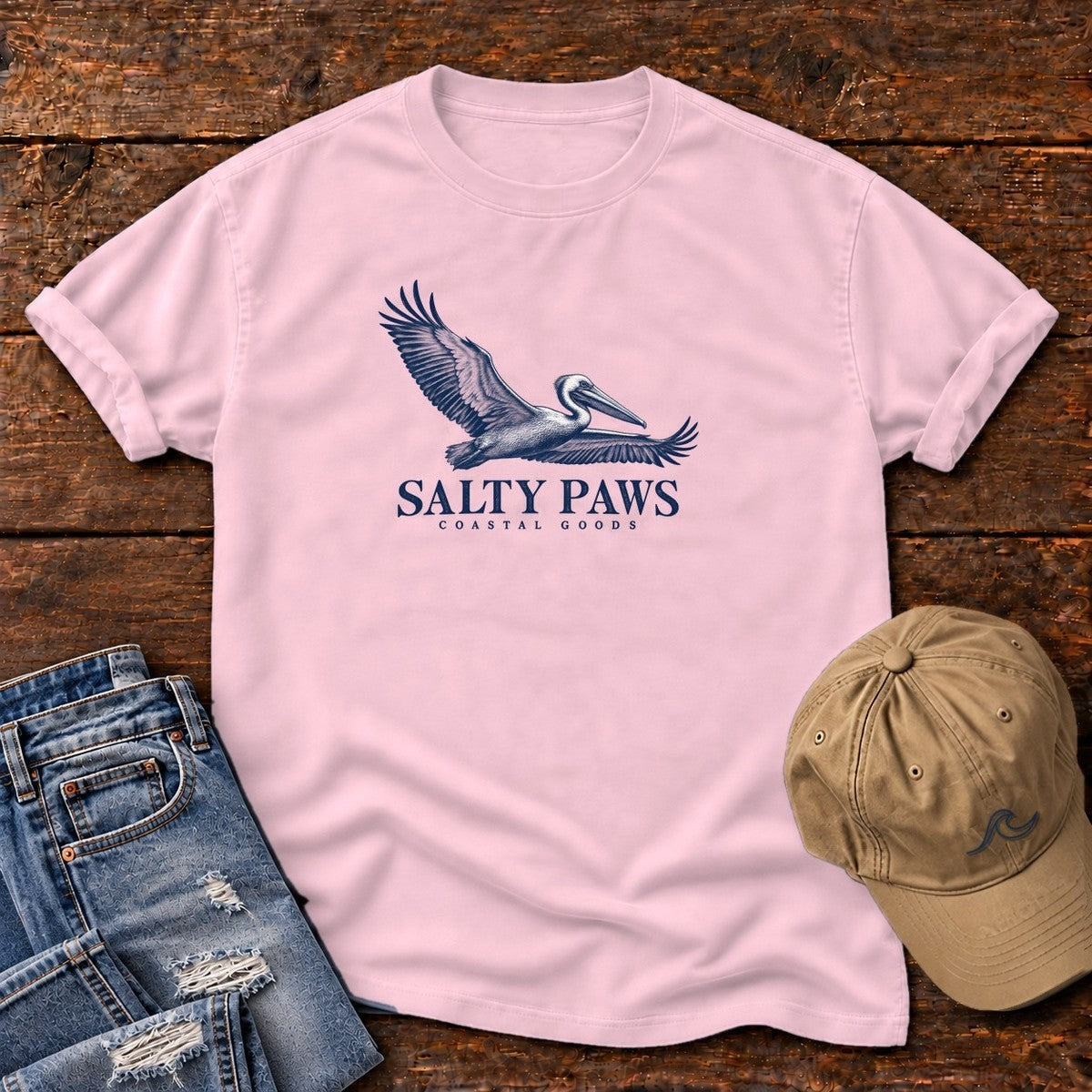 Gliding Pelican Coastal Goods T-Shirt in Blossom, Salty Paws Comfort Colors T-Shirt, front design flat lay