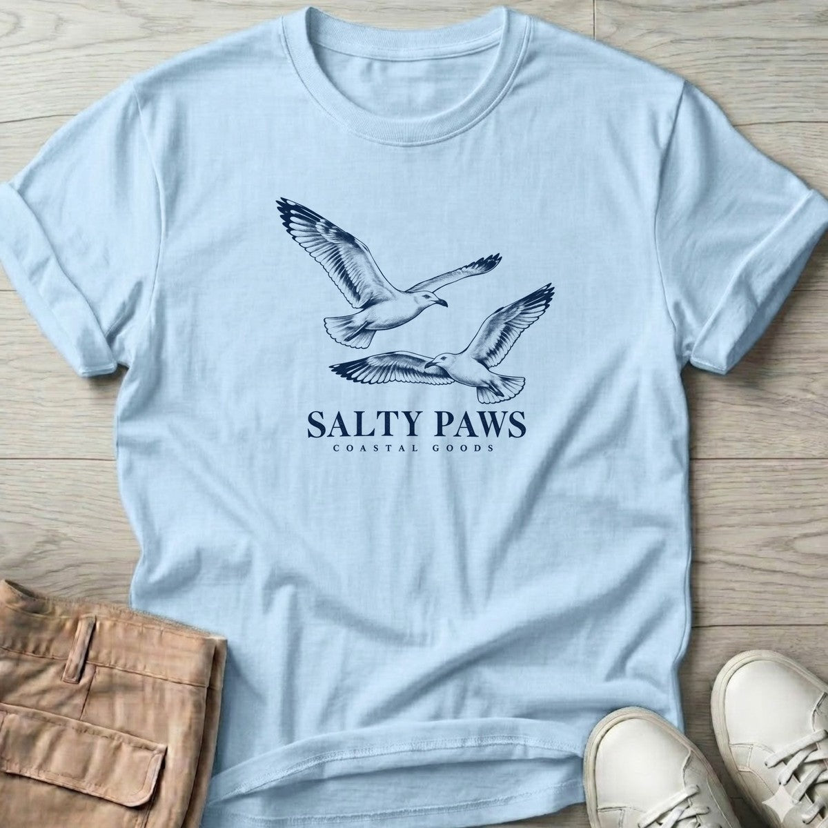 Gull Flight Coastal Goods T-Shirt in Light Blue, Salty Paws T-Shirt, front design flat lay