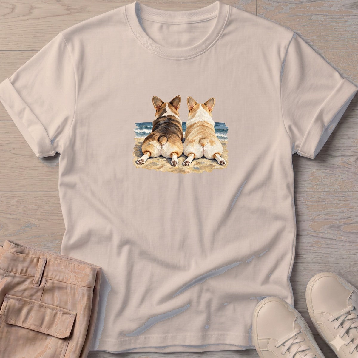 Two Corgis at the Ocean T-Shirt in Sand, Salty Paws T-Shirt, front design flat lay