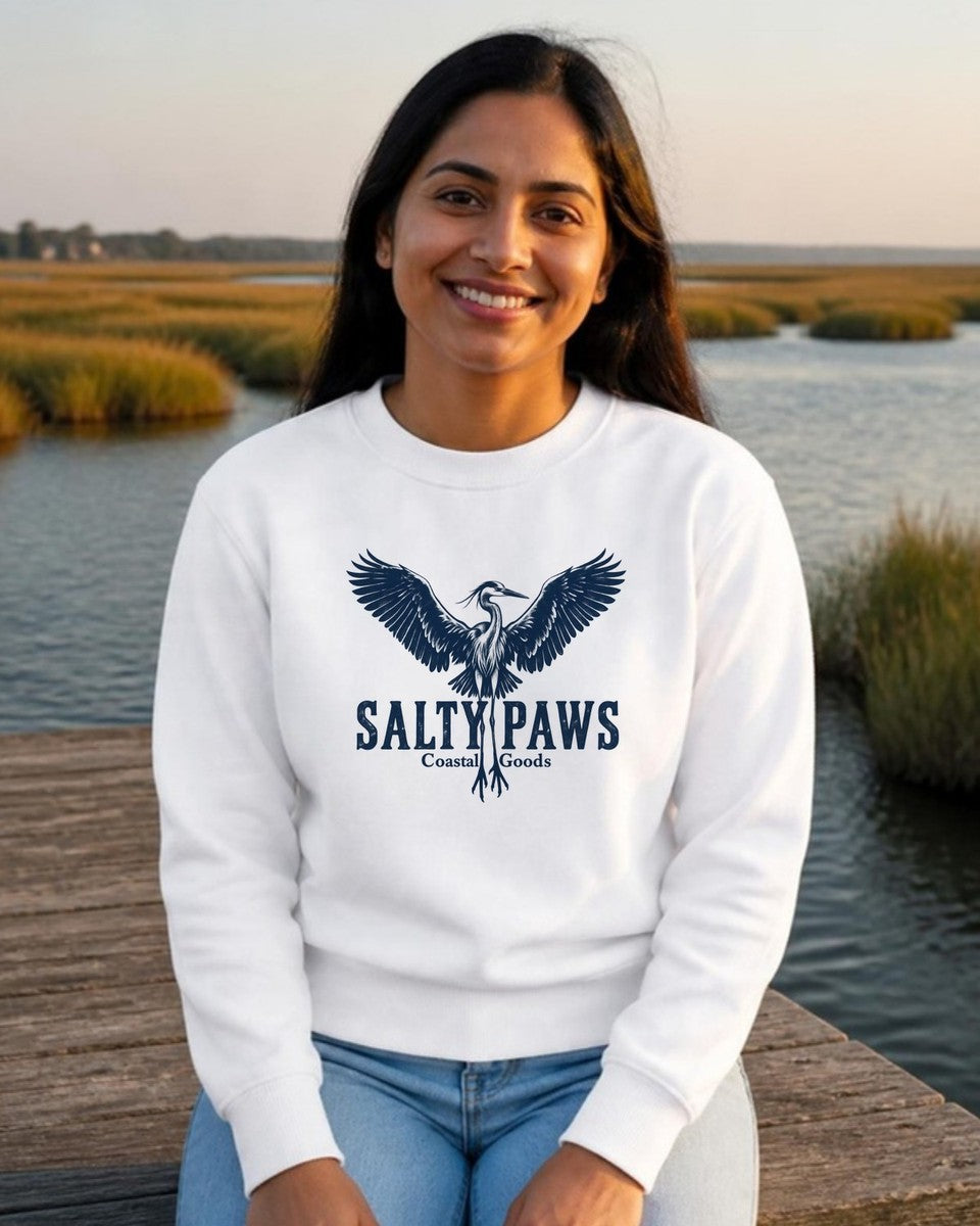 Rising Heron Salty Paws Coastal Goods Midweight Sweatshirt in White, worn by a model on a marsh dock, front design