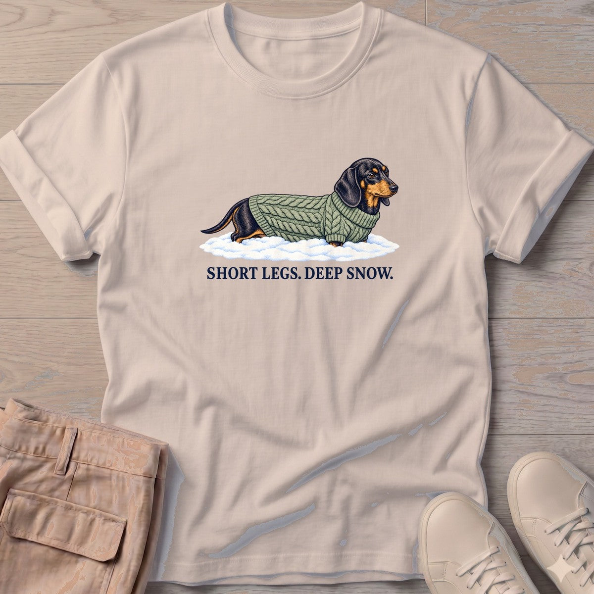 Short Legs Deep Snow Dachshund T-Shirt in Sand, Salty Paws T-Shirt, front design flat lay