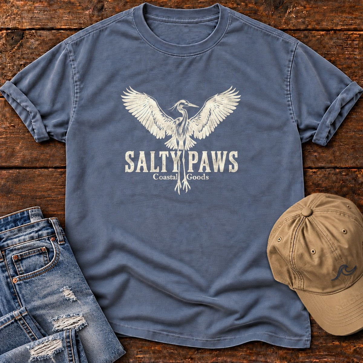 Rising Heron Salty Paws Coastal Goods T-Shirt in Blue Jean, Salty Paws Comfort Colors T-Shirt, front design flat lay