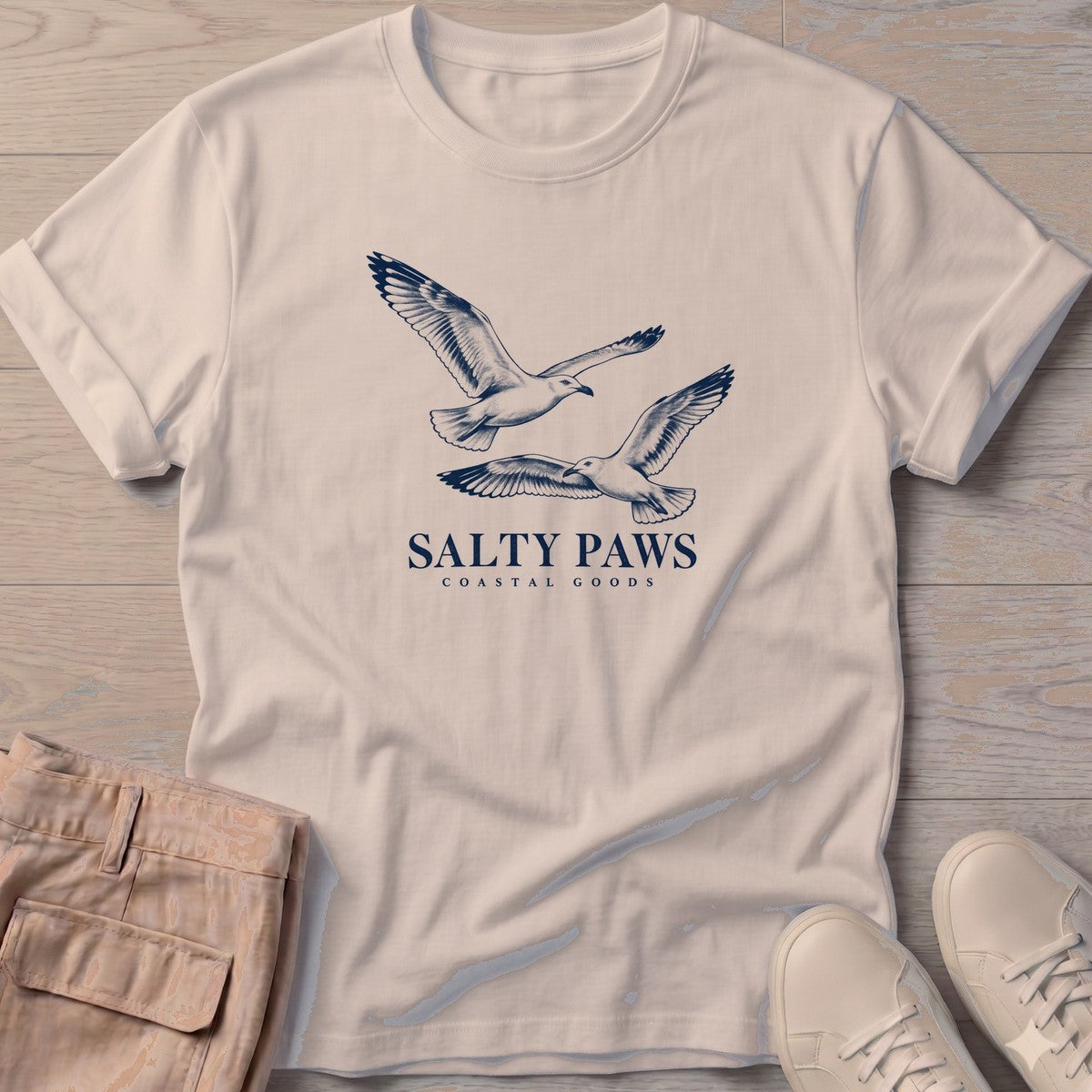 Gull Flight Coastal Goods T-Shirt in Sand, Salty Paws T-Shirt, front design flat lay
