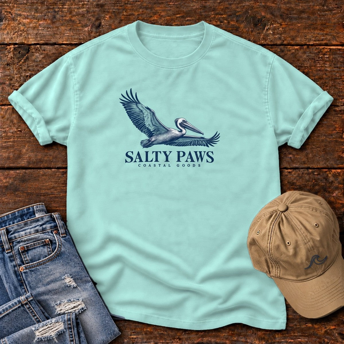 Gliding Pelican Coastal Goods T-Shirt in Chalky Mint, Salty Paws Comfort Colors T-Shirt, front design flat lay