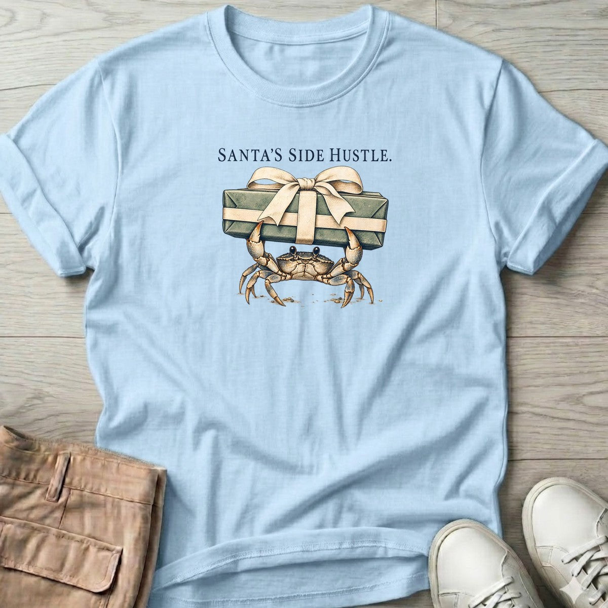 Santa's Side Hustle Crab T-Shirt in Light Blue, Salty Paws T-Shirt, front design flat lay
