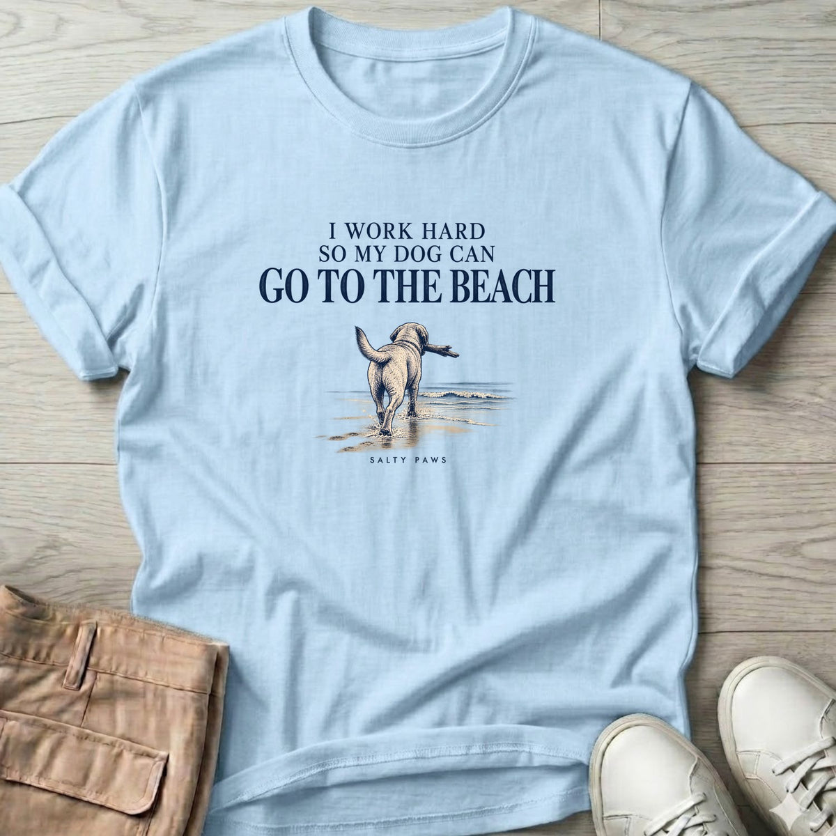 I Work Hard So My Dog Can Go to the Beach T-Shirt in Light Blue, Salty Paws T-Shirt, front design flat lay