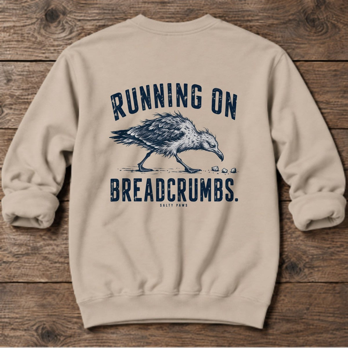Running on Breadcrumbs Seagull Back Design Midweight Sweatshirt in Sand, Salty Paws Midweight Sweatshirt, back design flat lay