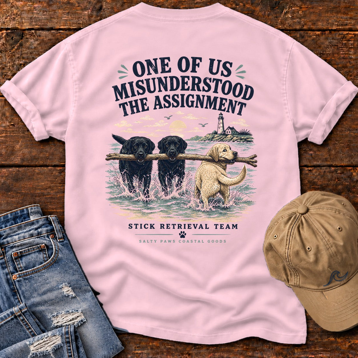 One of Us Misunderstood the Assignment Comfort Colors T-Shirt in Blossom, back design flat lay