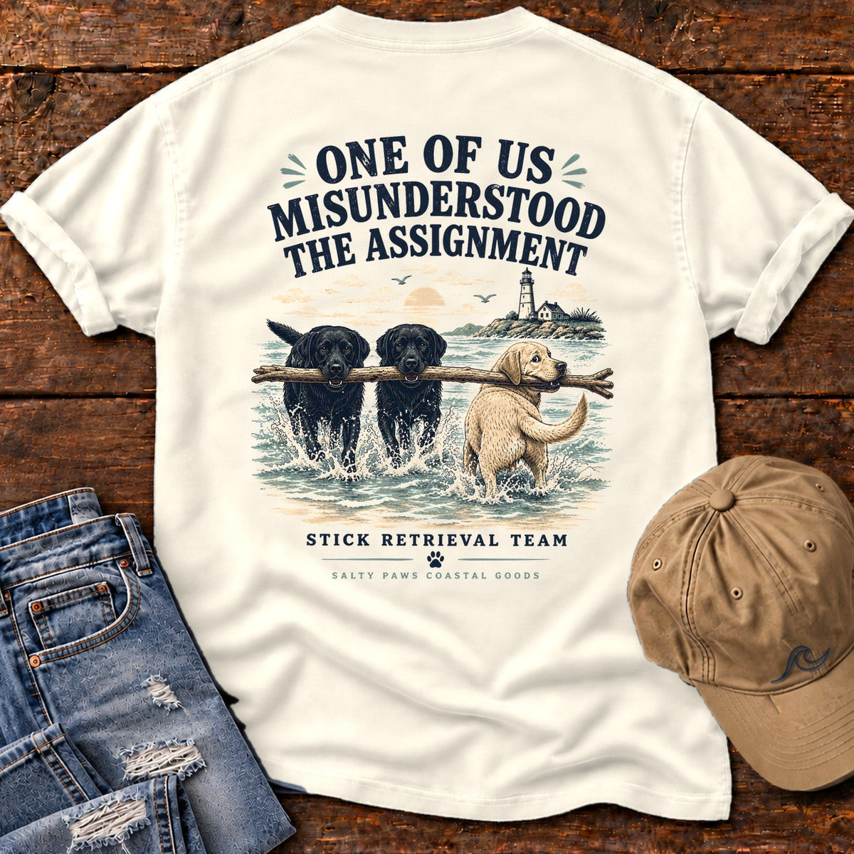 One of Us Misunderstood the Assignment Comfort Colors T-Shirt in Ivory, back design flat lay