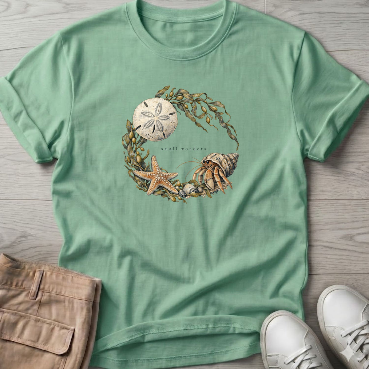 Small Wonders Sand Dollar T-Shirt in Mint Green, Salty Paws Soft Style T-Shirt, front design flat lay