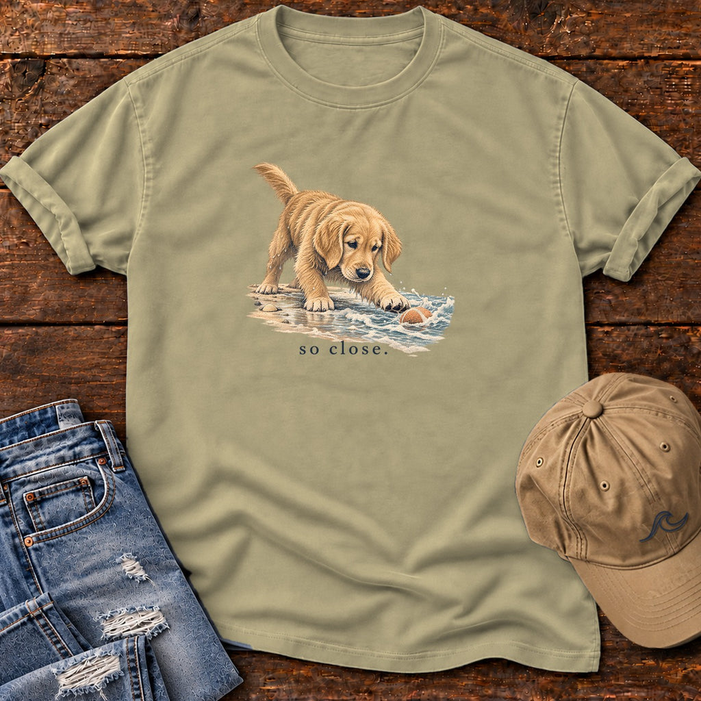 So Close Golden Retriever Puppy T-Shirt in Khaki, Salty Paws Comfort Colors T-Shirt, front design flat lay