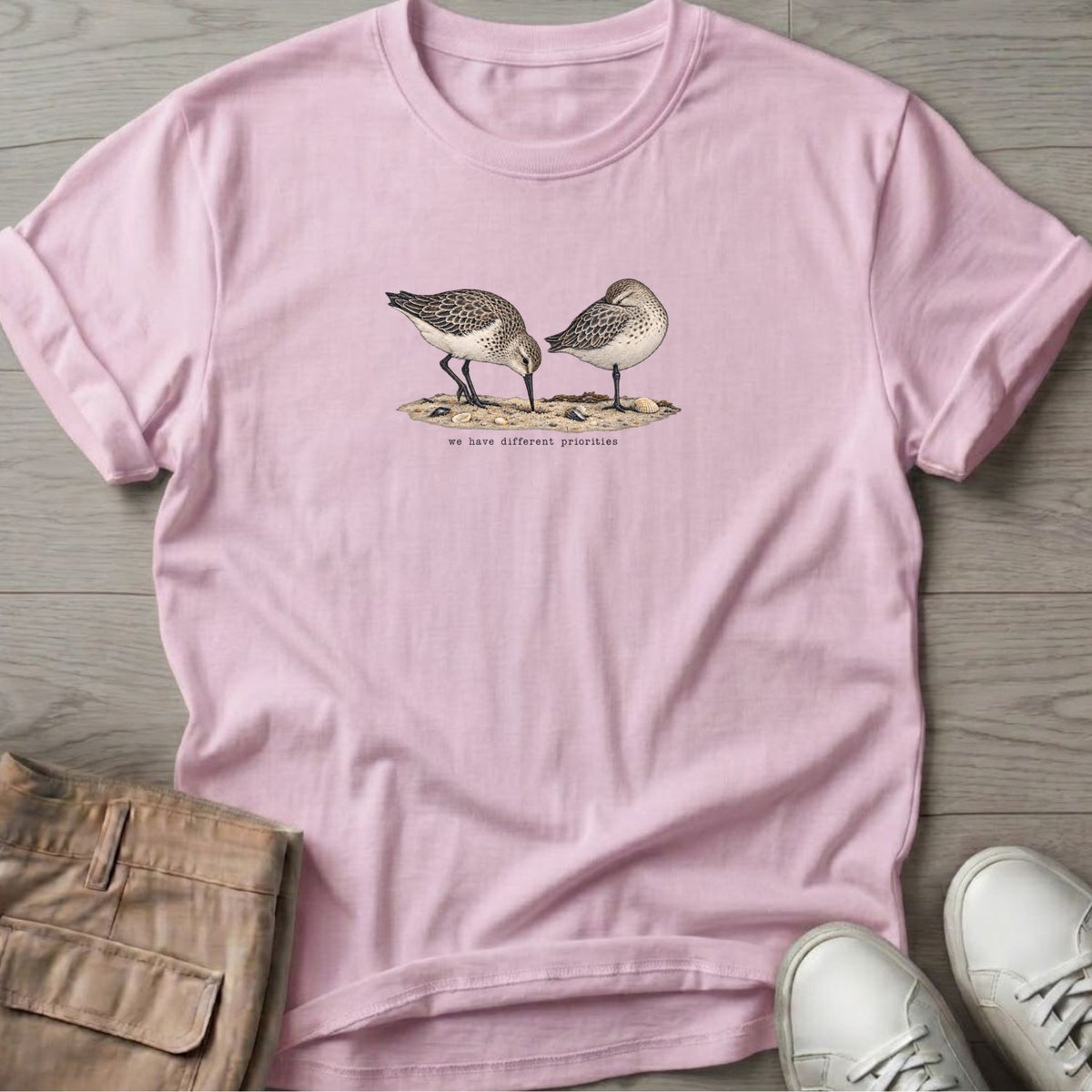 We Have Different Priorities Sandpipers T-Shirt in Light Pink, Salty Paws Soft Style T-Shirt, front design flat lay
